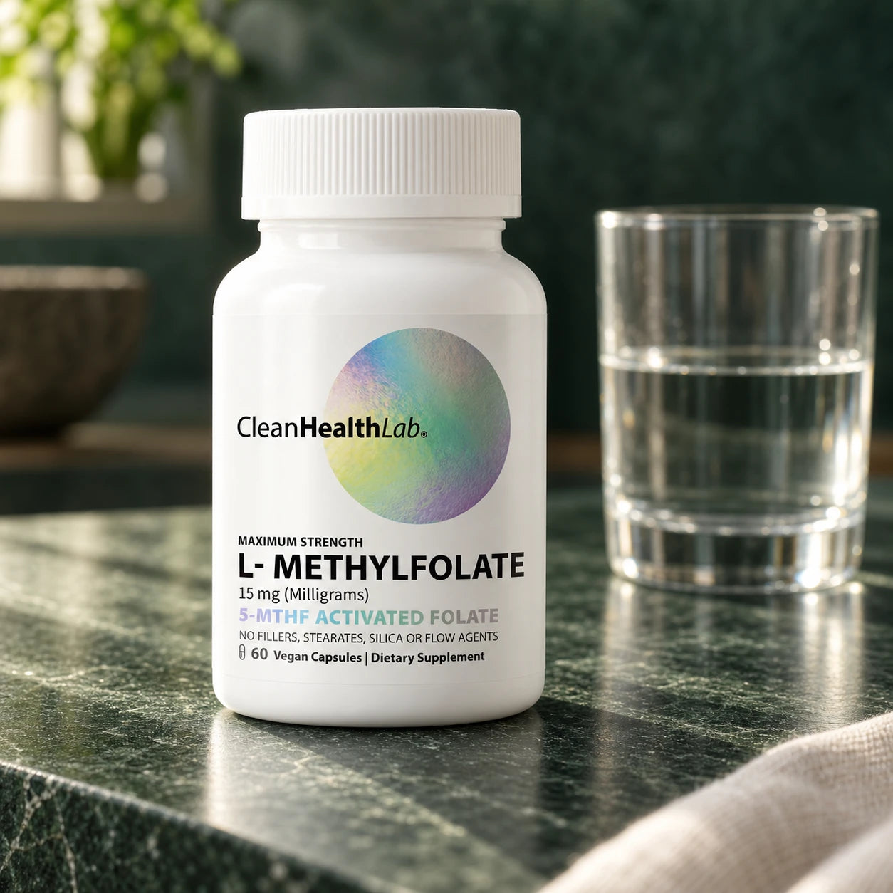 Clean Health Lab L-Methylfolate beside a glass of water on a green stone counter.