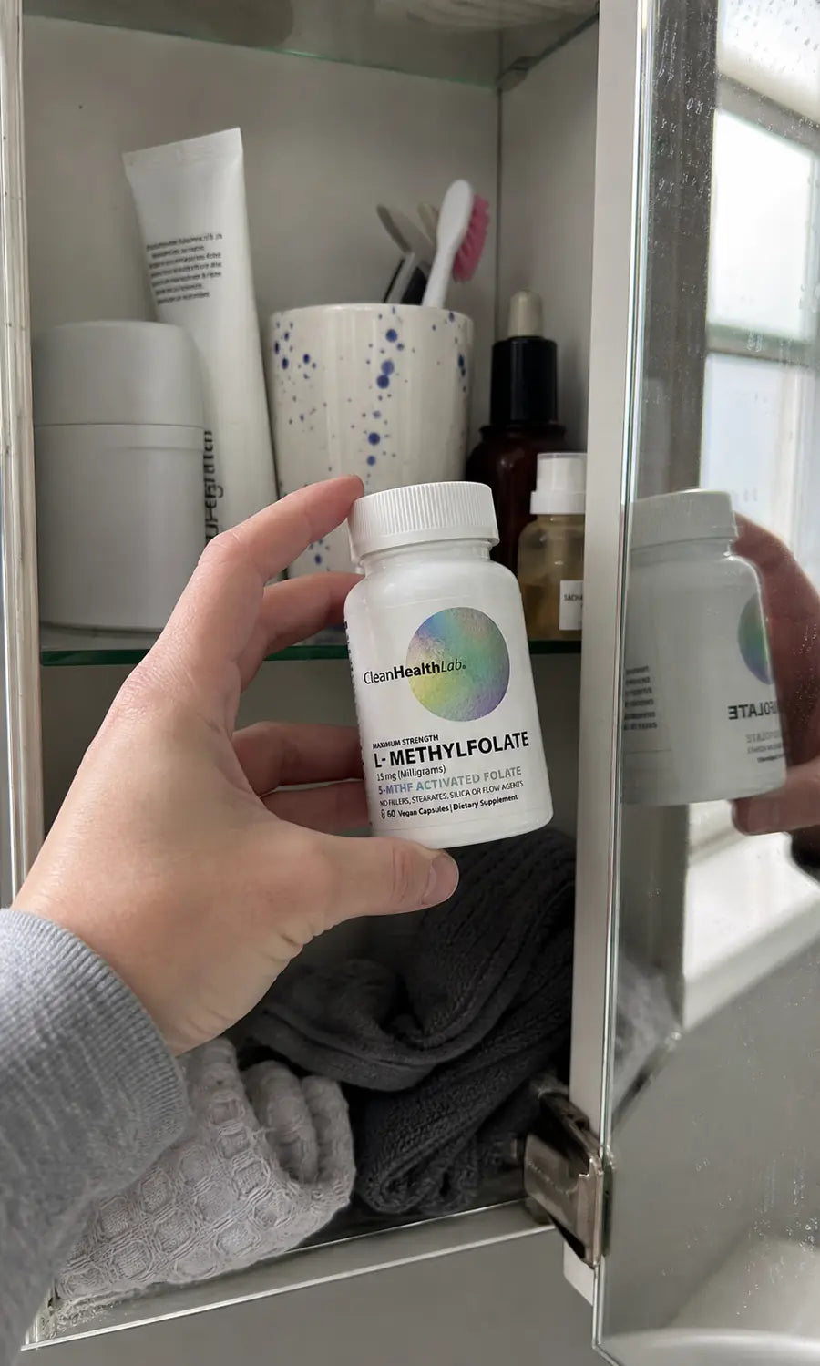 Compact bottle stored on a bathroom shelf